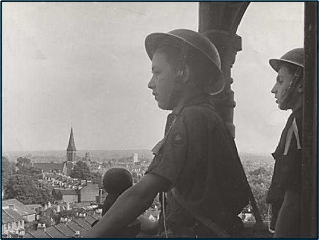 boy scout in warden's helmet
