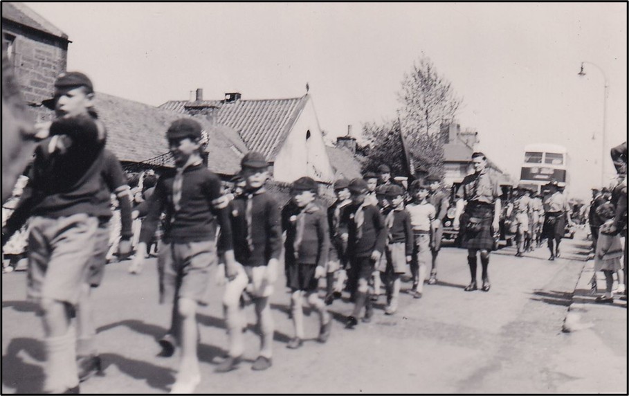 cubs marching on a road circa 1950s