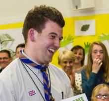 scout leader holding certificate