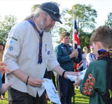 Gareth Alexander handing out badge to scout