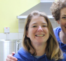 Woman smiling in blue hoodie