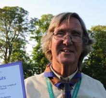 Steve smiling holding a certificate