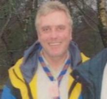 man in scout uniform smiling