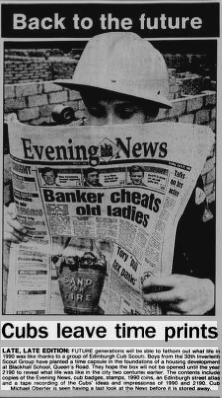 Newspaper article showing boy in Cub uniform reading newspaper